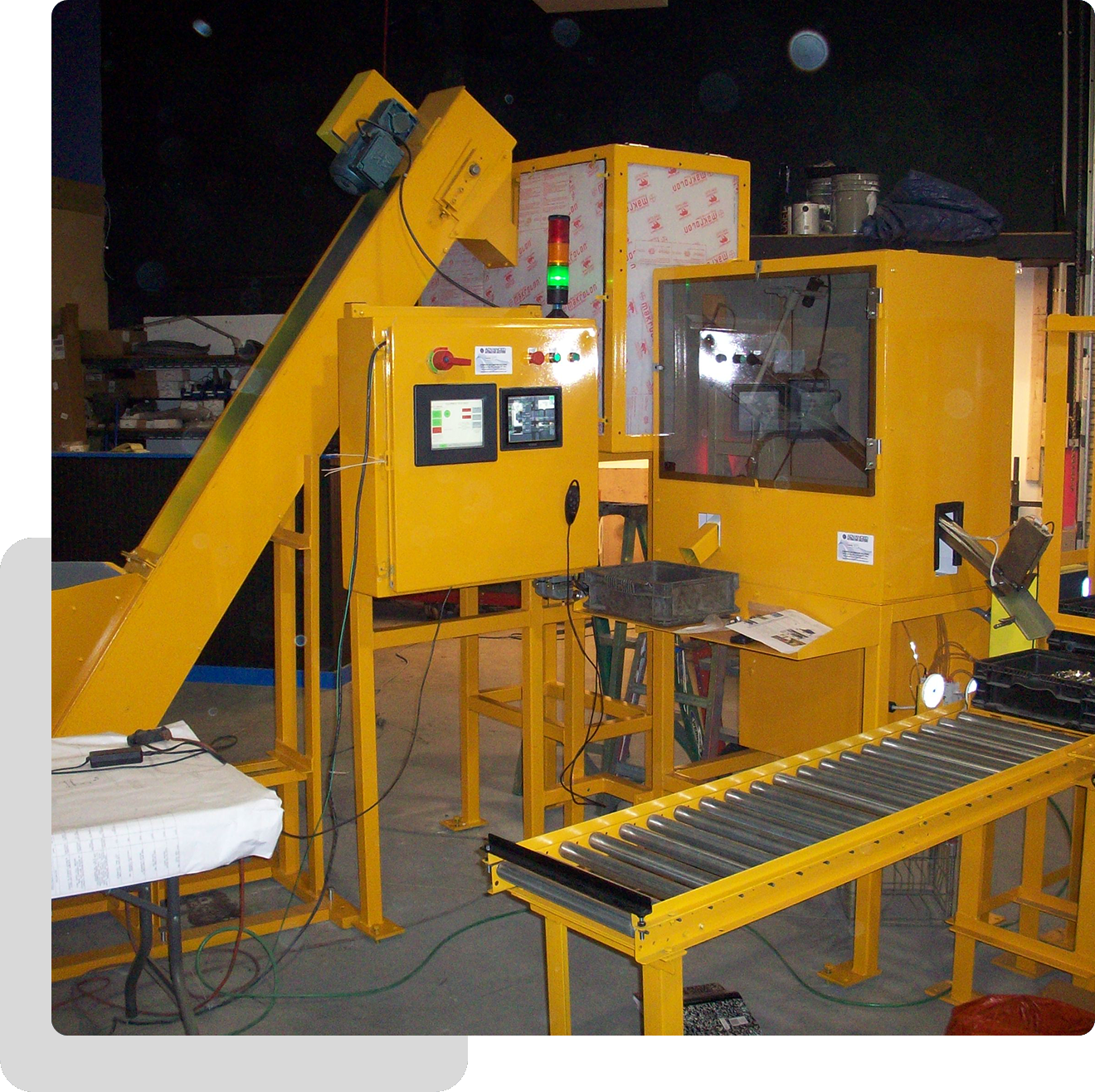 A yellow machine with a conveyor belt and other machinery.